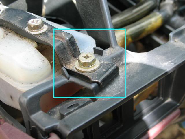 Screws located above brake fluid reservoir