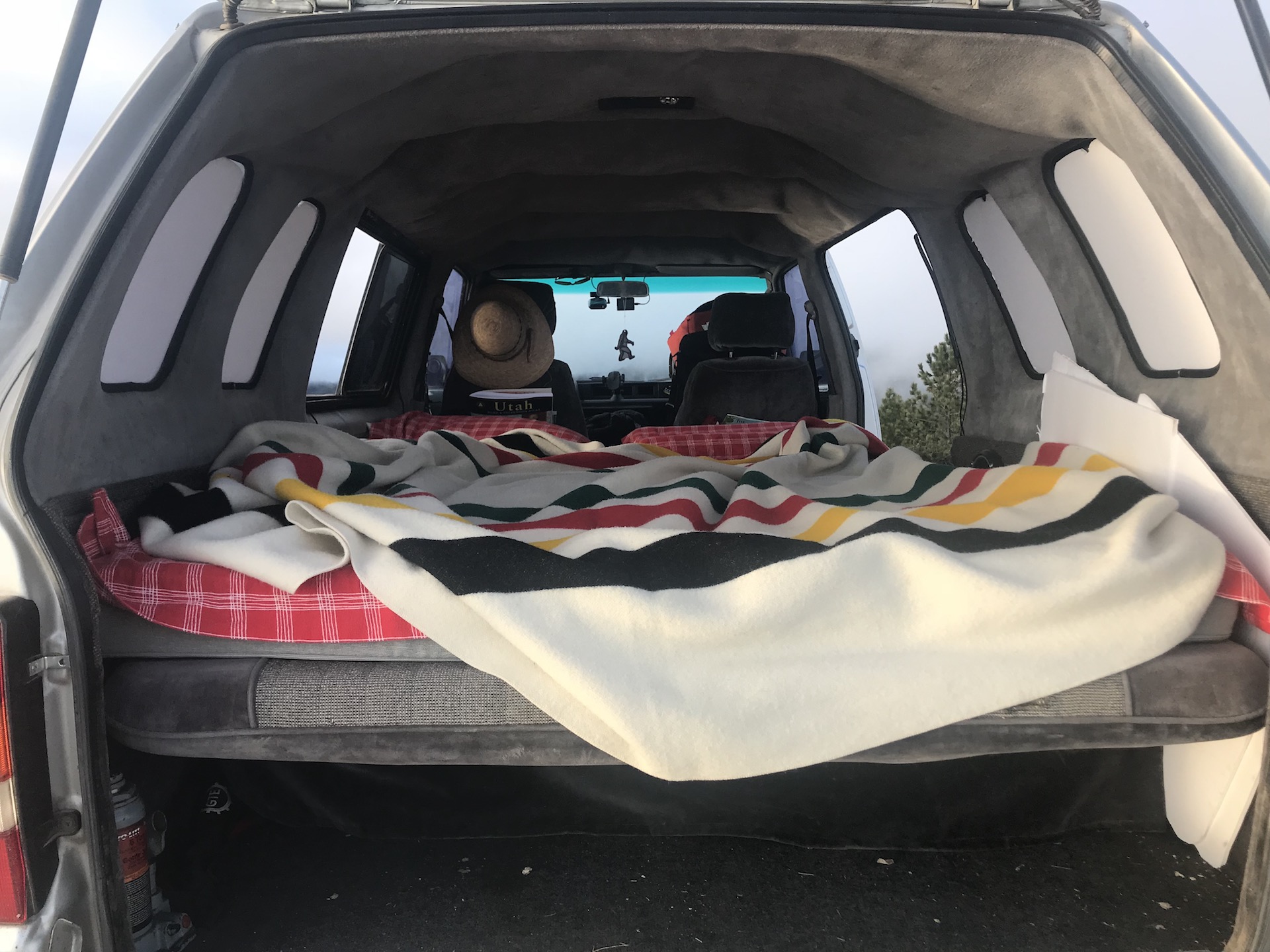 Our cozy bed and Pendleton wool blanket in the Toyota Van