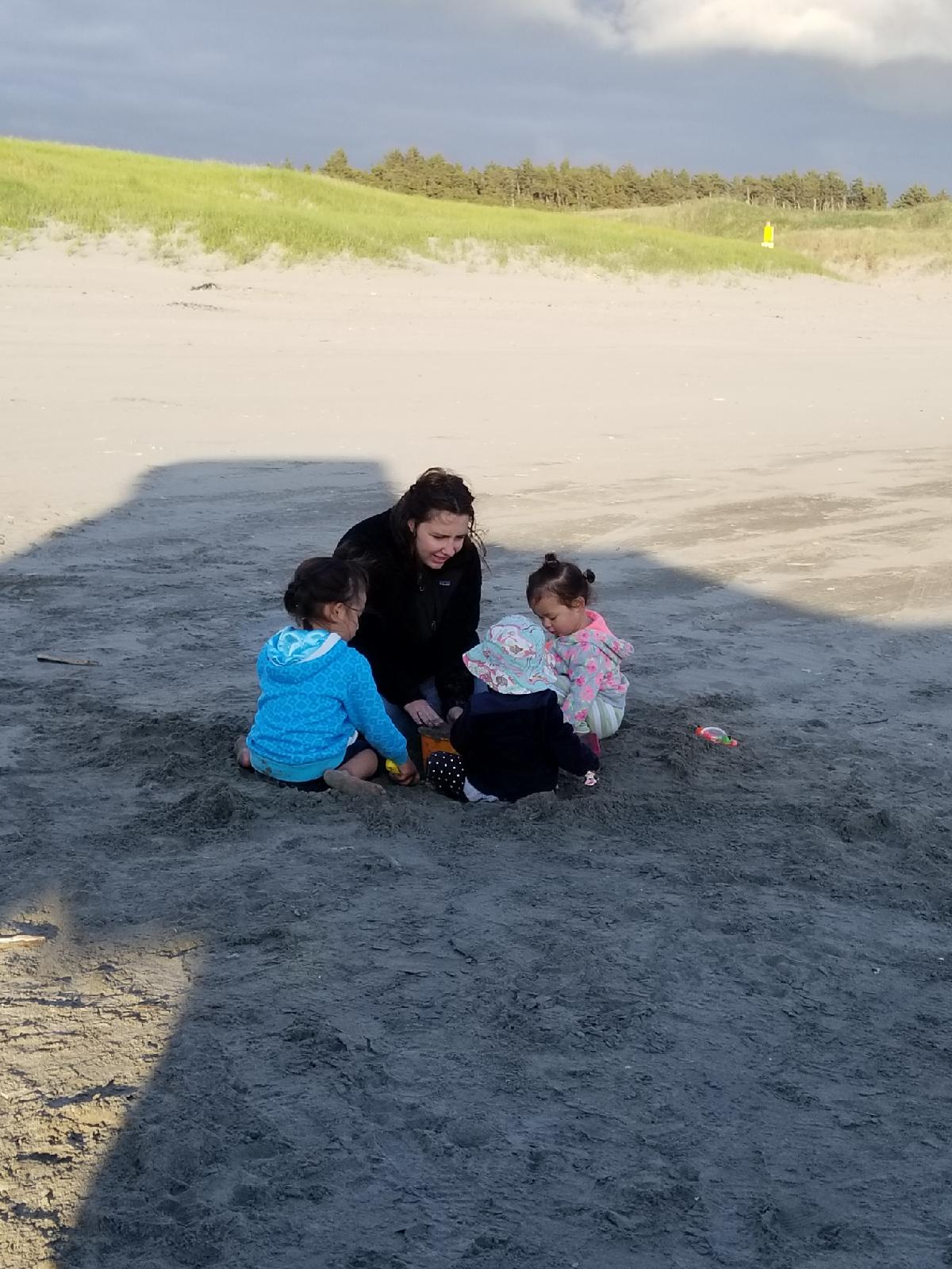 Playing in the sand on the beach in Oregon